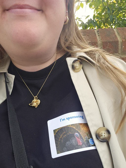 A selfie that shows me wearing a sticker that says "I sponsor Gregory Peck"