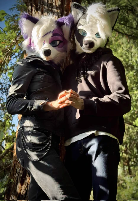 Koko and Cino in fursuit holding hands showing off their wedding rings
