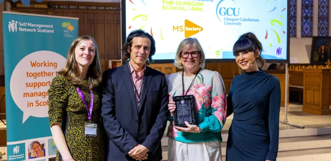 Photo by photographer Iman Tajik shows Professor Lorna Paul receiving the award. Left to right - Health and Social Care Alliance Chief Officer Sara Redmond, Dr Matthieu Poyade, Professor Lorna Paul and awards host Laura Boyd.