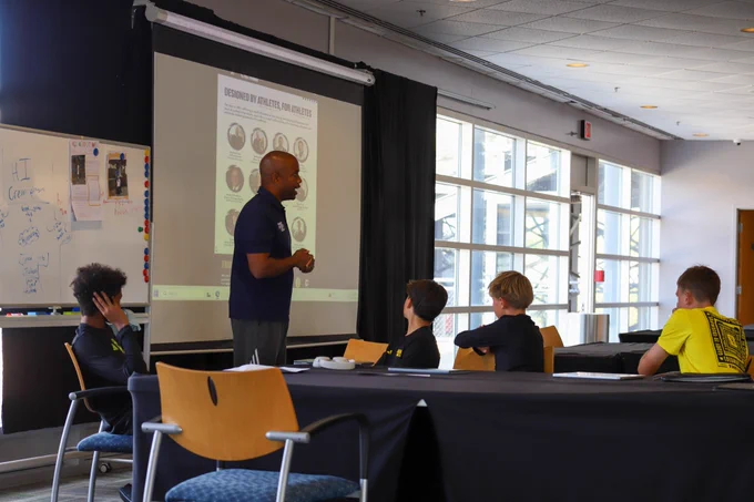 Photo of Rob Burlew from First Point USA speaking to Crew School students.