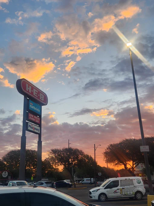 Colorful clouds at sunrise, viewed from an HEB grocery store parking lot 