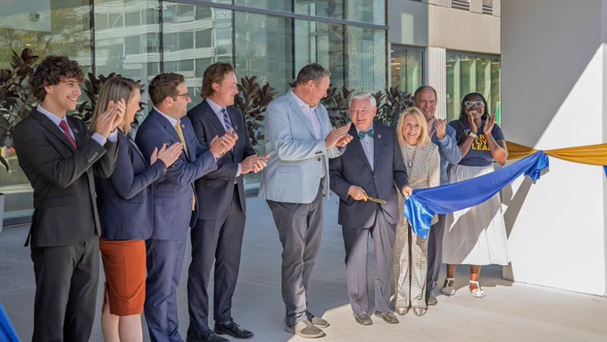 Husam Morra, president of the University of Windsor Students’ Alliance, Gillian Heisz, vice-president finance and operations, Michael Kaye, partner at Tilbury Properties, Jack Federer, partner at Tilbury Properties, J.J. McMurtry, president and vice-chancellor, Don Rodzik Sr., Gail Rodzik, Dwight Duncan, chancellor, and Promys Robinson, student and residence community assistant, cut the ribbon to officially open Rodzik Hall, the University of Windsor’s newest student residence
