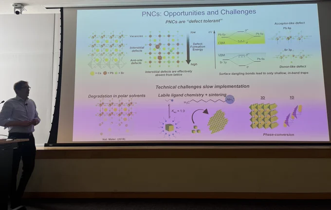 Prof. Todd Emrick from UMass Amherst stands to the left of a screen displaying a slide titled "PNCs: Opportunities and Challenges" from his seminar at Arizona State University's Biodesign Center for Sustainable Macromolecular Materials and Manufacturing 