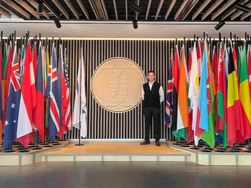 Lukasz Kolodziej MPA 2026 surrounded by countries' flags at the European Bank for Reconstruction and Development's London headquarters.