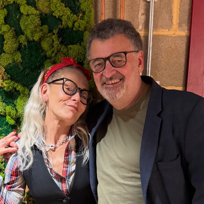 Tracie Bennett and Steven Moffat smiling at the camera.