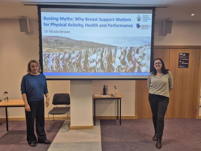 A photo of Prof Ailsa Niven and Dr Nicola Brown standing next to a presentation from Dr Brown