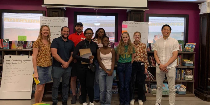 [Image: 826DC students stand with Washington Post reporters Perry Stein and Lauren Lumpkin, and local elected officials Benjamin Williams, Allister Chang, Robert Henderson, and Christine Miller posing for a picture in 826DC's program space]