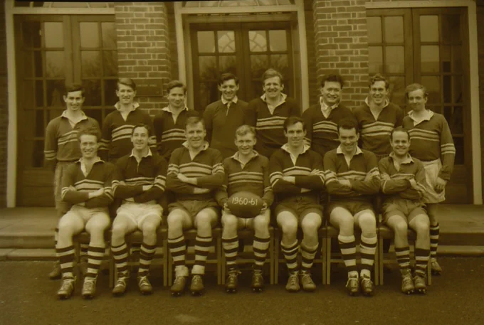Black and white photograph of a rugby team in front of Stafford Cripps building.