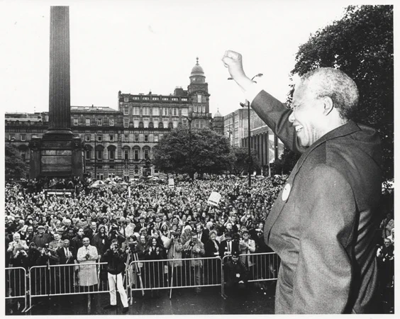 Nelson Mandela salutes the crowd in George Square, Glasgow on 9th Oct. 1993. After the formal presentation of the Freedoms in the City Chambers he addressed this large public rally in the Square