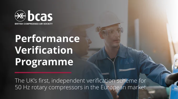 An image of two engineers in a manufacturing environment assessing equipment performance