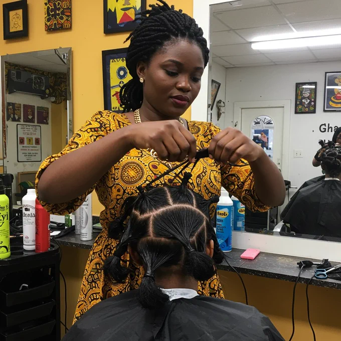 A Ghanaian hairstylist working on traditional African threading using black rubber threads to stretch and shape the client’s hair. The salon is cheerful, decorated with bright colors and African prints. The stylist wears a gold necklace and has her tools neatly arranged on a counter.