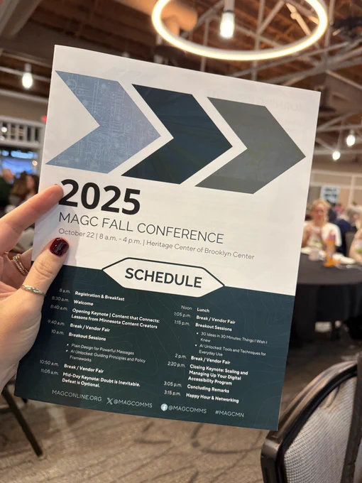 An image of a hand holding a program for the MAGC Fall Conference.