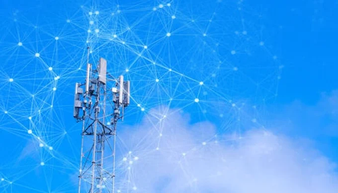 Telecommunication tower under a clear blue sky with digital network connections representing data transmission and connectivity — concept of modern telecom innovation and Network Edge technology.