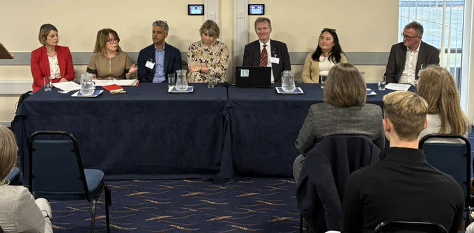 A panel of seven people holding a discussion