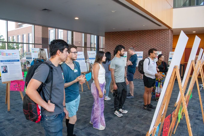 Group of people looking at Hispanic Heritage Month posters. 