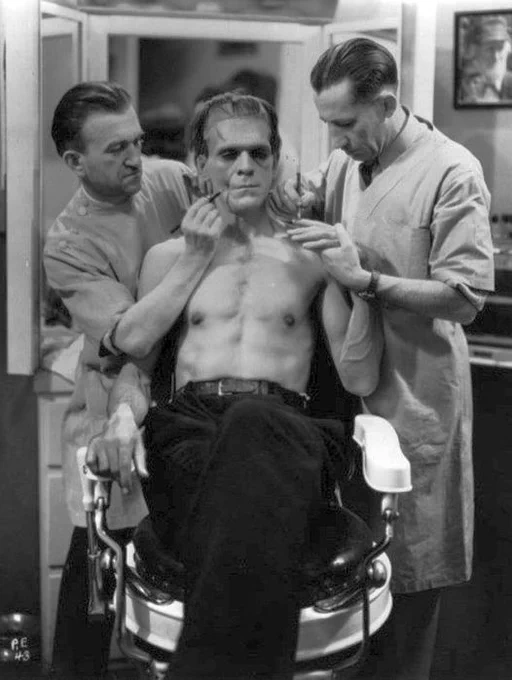 Boris Karloff having his makeup done for Frankenstein.