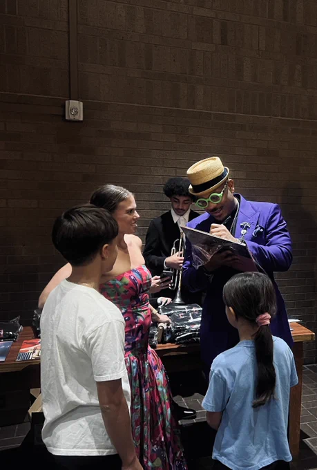 Artist signs autographs backstage