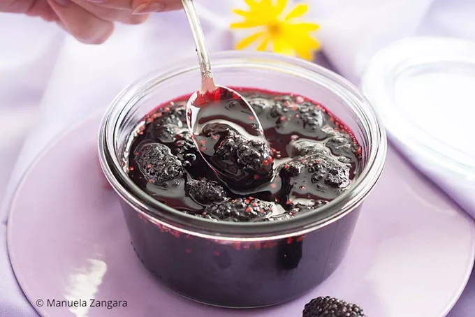 Finished mulberry jam stored in a glass jar.