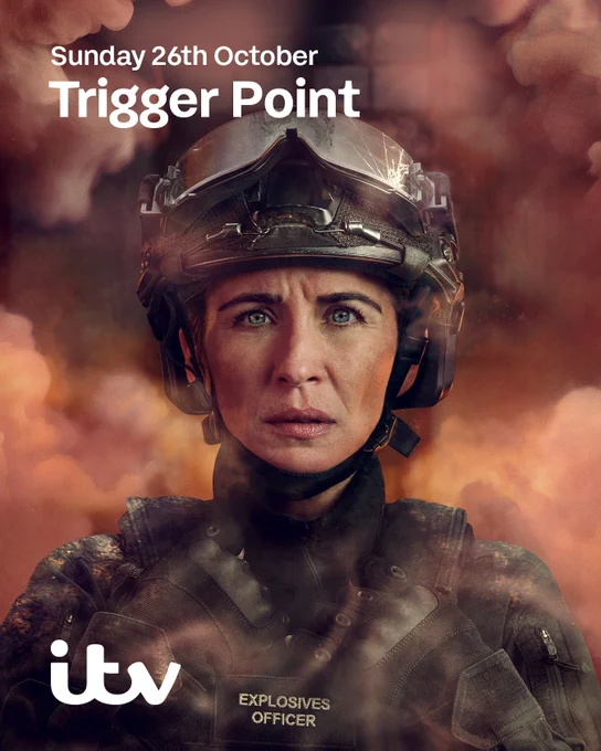 Vicky McClure as bomb disposal officer Lana Washington, wearing a cracked helmet and protective gear, surrounded by smoke and orange light. Text on image reads: “Sunday 26th October, Trigger Point, ITV.”