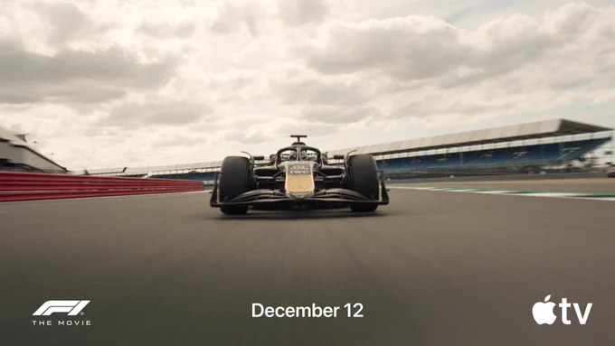 A photo of a race car driving in the middle of a race track.  At the bottom left side of the image is the F1 The Movie logo. In the middle of the image, text reads, "December 12." At the bottom right is the Apple TV logo.