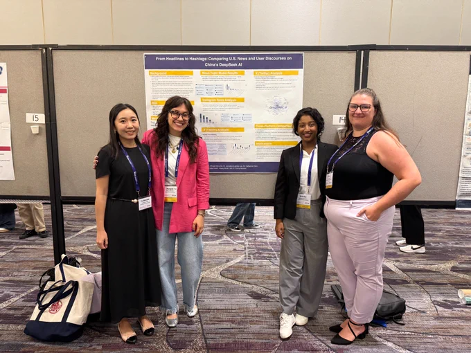 Dr. Chen, Morgan, Nabila, and Caley in front of the SMAC Lab poster for the paper “From Headlines to Hashtags: Comparing U.S. News and User Discourses on China’s DeepSeek AI”