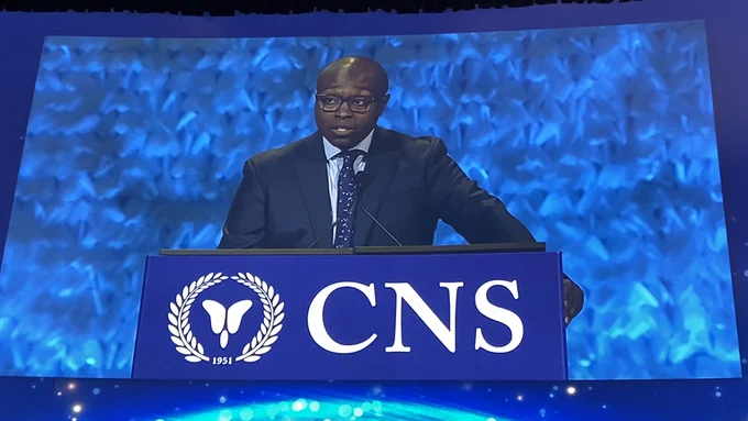The big screen showing UCSF neurosurgeon Shawn Hervey-Jumper, MD, at the podium delivering his presentation.
