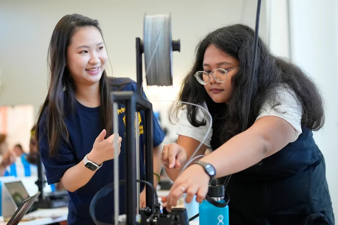Two students arrange the filament. (Photo by Adam Lau / UC Berkeley Engineering)