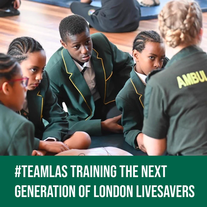 A photo of school pupils learning how to save a life with an LAS Community Resuscitation Trainer. Text reads: '#TeamLAS training the next generation of London Lifesavers'