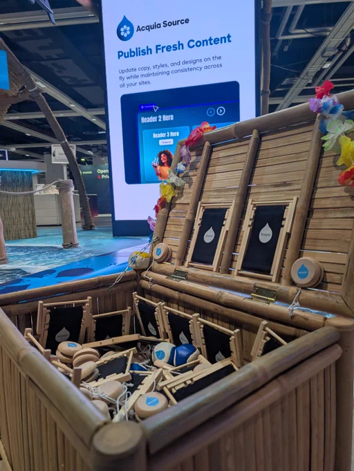 Open bamboo chest filled with branded wooden tokens and small frames at a tech event booth.