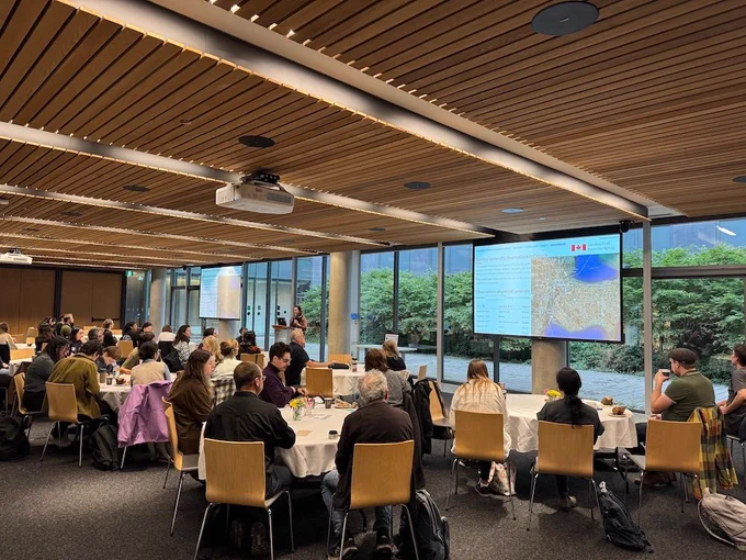 Attendees of the 2024 ESBC meeting seated in a conference room watching one of many scientific presentations.