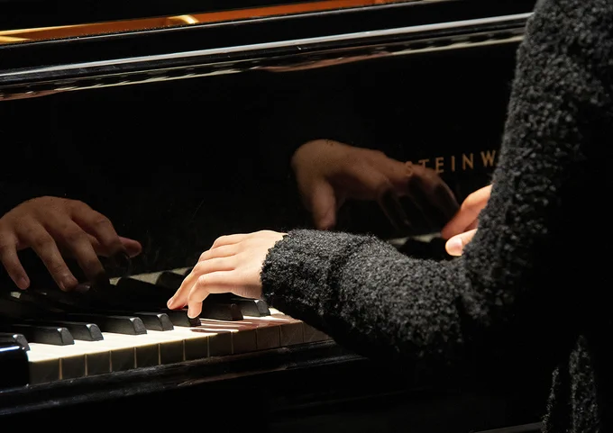 close-up of student playing the piano