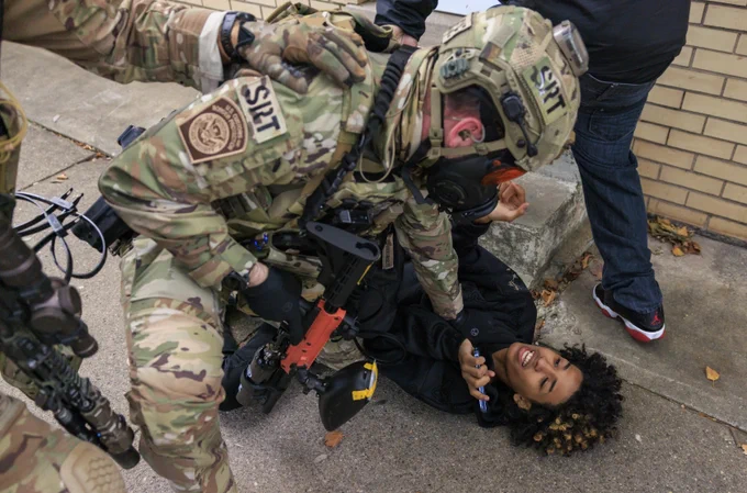 Federal immigration enforcement agents detain a protester during a skirmish at East 105th Street and South Avenue N in East Side.

Photo Credit: Anthony Vazquez/Sun-Times