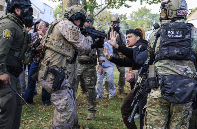 A U.S. Immigration and Customs Enforcement agent points a crowd control weapon at a protester Tuesday at East 105th Street and South Avenue N in the East Side neighborhood.

Photo Credit: Anthony Vazquez/Sun-Times