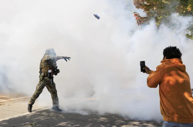 An ICE agent throws a tear gas canister at protesters at East 105th Street and South Avenue N in East Side.

Photo Credit: Anthony Vazquez/Sun-Times