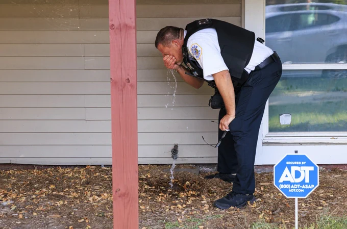 A Chicago Police Department officer washes his face after being exposed to tear gas during a protest at East 105th Street and South Avenue N in East Side.

Photo Credit: Anthony Vazquez/Sun-Times