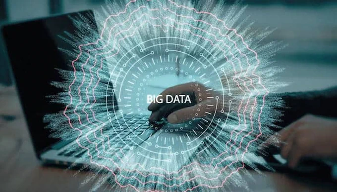 A person typing on a laptop with a digital holographic interface displaying the words “BIG DATA,” symbolizing analytics, technology, and a modern data resilience strategy.