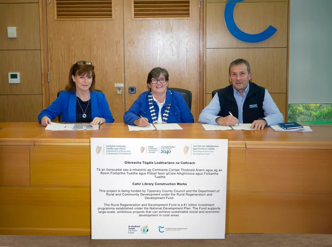 A picture of Sinéad Carr (Chief Executive Tipperary County Council), Councillor Marie Murphy (Leas Cathaoirleach) and Joe Mulcahy (Mulcahy Construction) signing contracts.