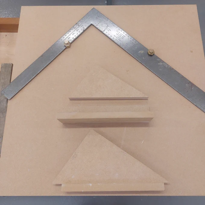 Top is a roofing square with guides showing the Rise and Going plus margin. 
Middle is the triangle with the Rise and Going on it and a separate L shaped guide with the 30mm margin. 
Bottom is a template with the triangle with the Rise and Going on it and the 30mm margin.
