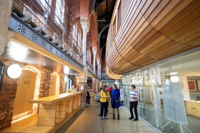 Picture of people being given a tour around Ashton Old Baths
