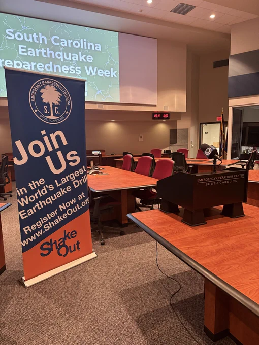 Image of the State Emergency Operations Center with a banner for the great shakeout and a podium.