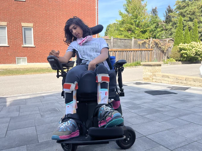 Anchel's daughter, who uses a power chair, posed outside 