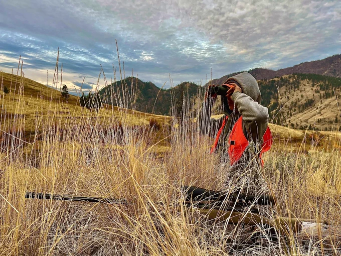 A young hunter glasses for deer on public lands in north-central Washington’s Okanogan County during the 2024 Big Game hunting season. Photo by Jessie Korr.