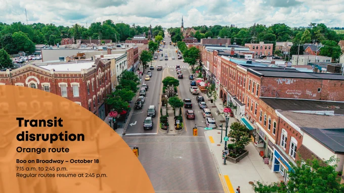An aerial shot of a small town street. Text on the photo reads: "Transit disruption - Orange route. Boo on Broadway, October 18."