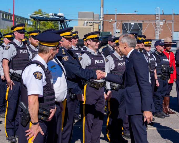 Prime Minister Carney makes an announcement alongside RCMP personnel in Etobicoke, Ontario.