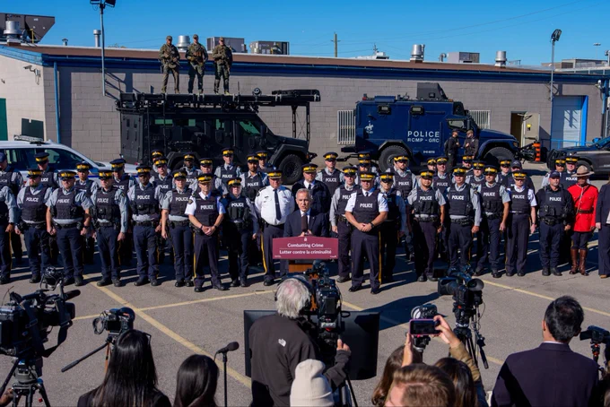 Prime Minister Carney makes an announcement alongside RCMP personnel in Etobicoke, Ontario.