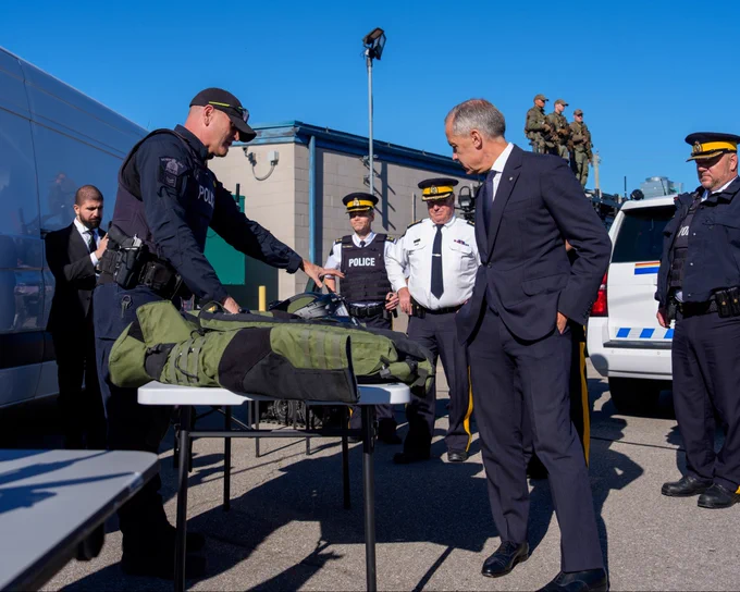 Prime Minister Carney makes an announcement alongside RCMP personnel in Etobicoke, Ontario.