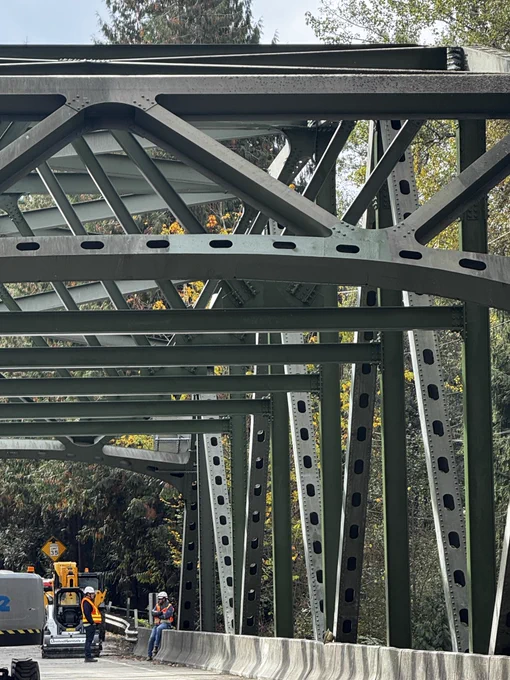 Green structural steel beam on a bridge.