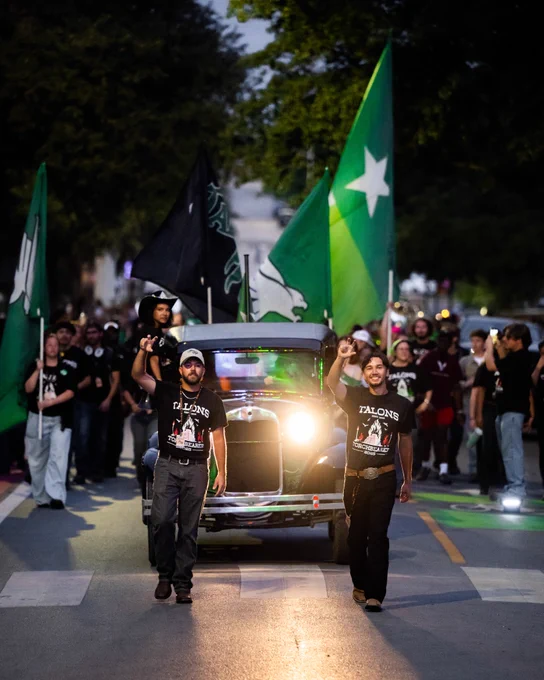Members of Talons lead the Spirit March to the Homecoming Bonfire.