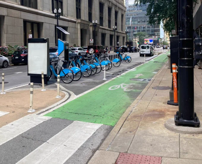 New Divvy station between bike lane and travel lane outside City Hall