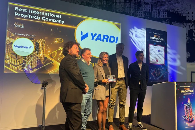 Group of five people on stage (including Mike Hobbs, Georgie Drewery, Mark Savage, Matt Glenny from Yardi) at a Property Week's Tech Innovation Awards, receiving an award for Best International PropTech Company, with Yardi as the category winner. The stage features a large Yardi logo and promotional banners.